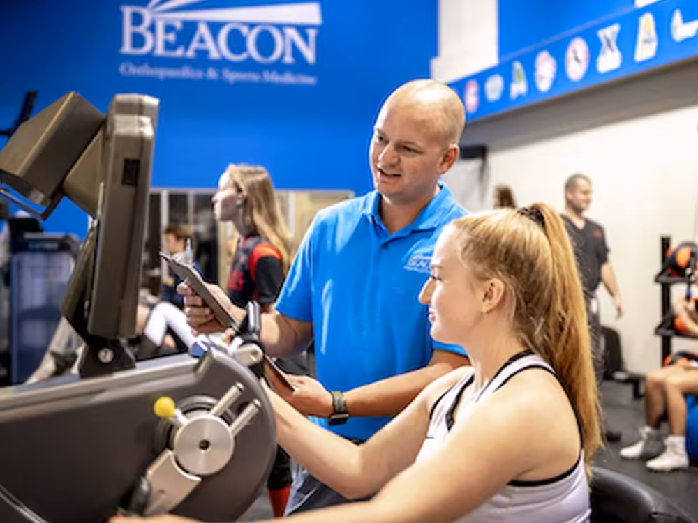 Physical-Therapy-Services Beacon Orthopedics doctor reviewing patients progress in rehab