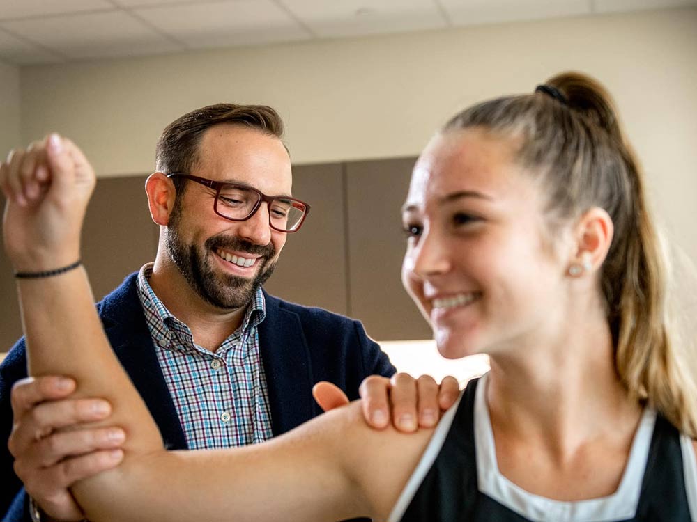 Beacon Orthopedic doctor seeing a patient about ongoing shoulder pain