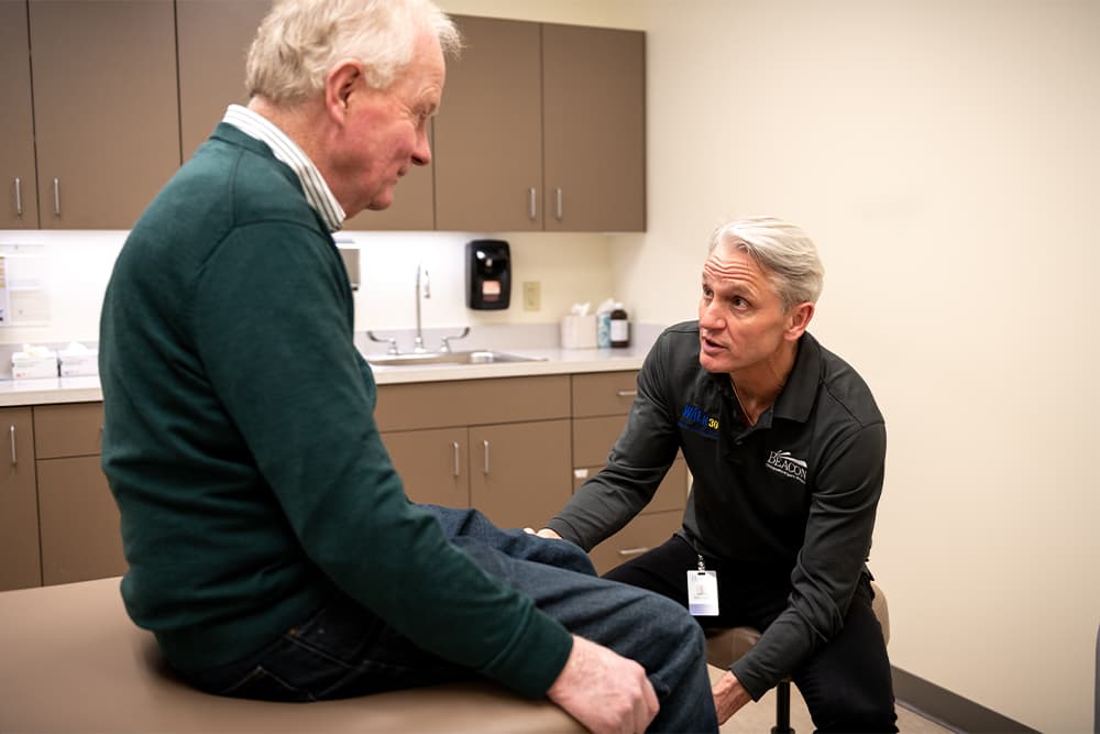 Dr. Swank holding patient's knee