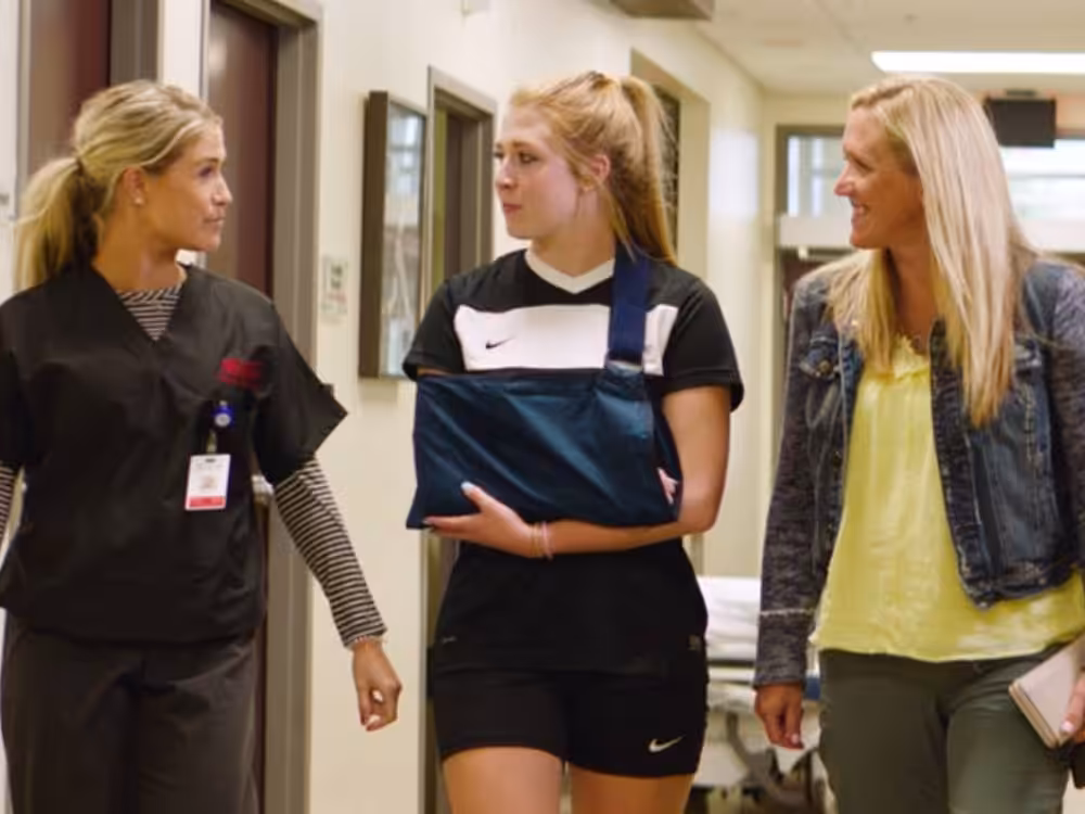 Urgent-Care Beacon Orthopedics doctor escorting patient and mother to door after setting a broken arm in Urgent Care