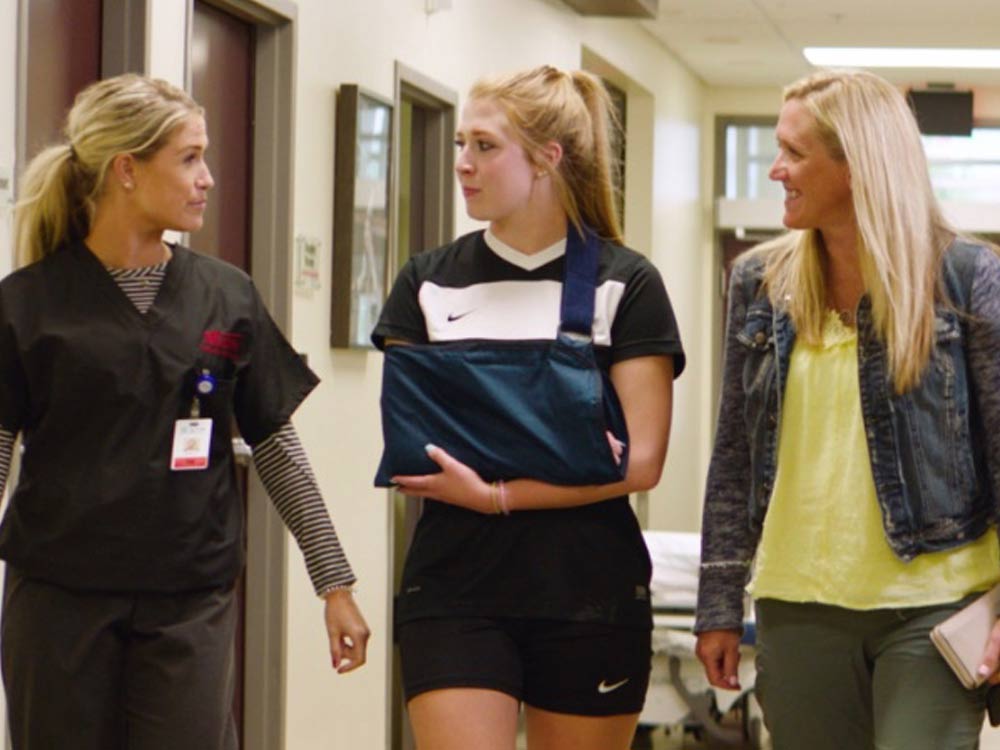 Beacon Orthopedics doctor escorting patient and mother to door after setting a broken arm in Urgent Care